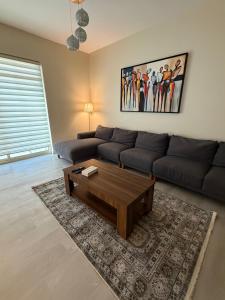a living room with a couch and a coffee table at شقة البيلسان فيو Baylasun View in King Abdullah Economic City