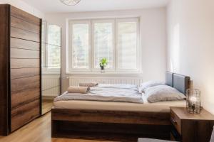 a bedroom with a bed and a large window at Apartment Spišská Nová Ves in Spišská Nová Ves