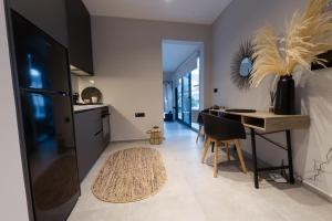 a kitchen and dining room with a table and a desk at Loft 77 Patras in Patra
