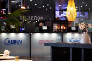 a bar with a person standing in the background at Cabinn Aarhus in Aarhus