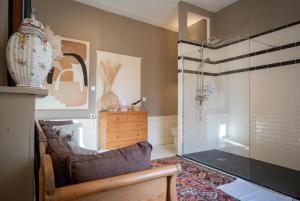 a bathroom with a shower with a glass door at Le Palais de la Cathédrale in Saint-Omer +12 photos