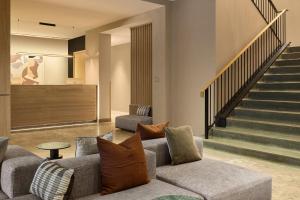 a living room with two couches and a staircase at Eurostars Old Montreal Suites & Apartments in Montreal