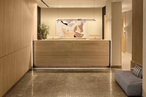 a lobby with a reception desk and a couch at Eurostars Old Montreal Suites & Apartments in Montreal