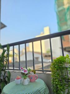 a table with potted plants on a balcony at Lishome My Khe Beach Apartment - An Thuong in Danang