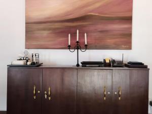 a wooden cabinet with two candles on top of it at Swarga Villa in Kandy +23 photos