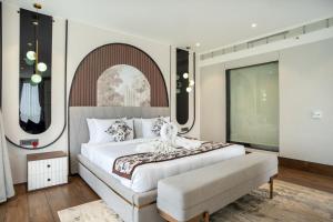 a bedroom with a large bed and a large window at Trinity Hotel Banquet & Spa in Siliguri