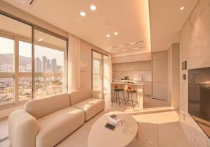 a living room with a couch and a table at Sota Suite Busan Seomyeon in Busan