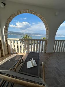a balcony with a table and a view of the ocean at Hotel Vila Tina in Trogir