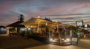 a restaurant with a sign in front of it at night at Motel 98 in Rockhampton