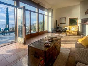 a living room with a large room with a large window at Villa Velta Calagrande in Porto Santo Stefano