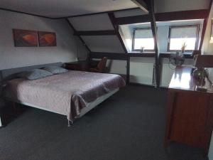 a bedroom with a bed and two windows at D'n Engel in Sittard