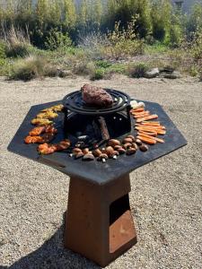 a grill with meat and vegetables on a table at Domaine Le Pineau Private Pool & Nordic Jacuzzi Loire Valley in Bléré