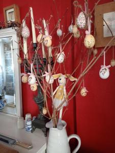 a vase filled with christmas ornaments on a tree at Le Presbytere in Beauficel +75 photos