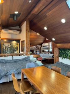 a bedroom with a bed and a table and chairs at Attico Inn ムーミン公園近く in Hanno