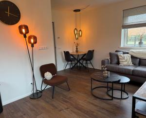 a living room with a couch and a table at Appartement Ocean Breeze Nes Ameland in Nes