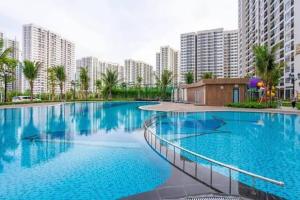 a large swimming pool in a city with tall buildings at VHGP-Bs10 in Long Bình