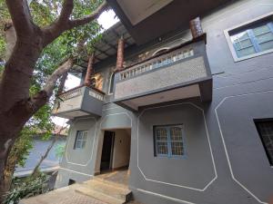 a house with a staircase on the side of it at Artjuna CoLiving in Assagao