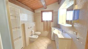 a bathroom with a toilet and a sink and a window at La Nocina in Raggio +23 photos