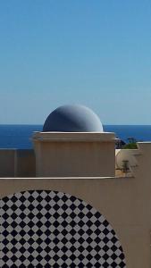 a dome on top of a building with a checkered floor at Vistarreal de Calarreona in Águilas