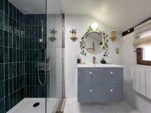 a bathroom with a shower and a sink and a mirror at Le Cottage des Chalands - classé 3 étoiles in Saint-Georges-sur-Cher +23 photos
