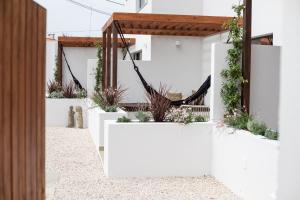 a white fence with plants on the side of a house at Viladraga - Casa da Adraga in Colares