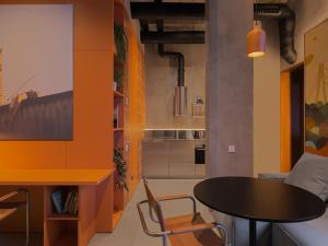 a kitchen with a table and a dining room at Lesi City Guide Hotel in Kyiv