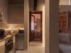 a kitchen with a hallway leading to a room at Lesi City Guide Hotel in Kyiv