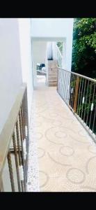 a balcony with a wooden railing and a staircase at Hotel center in Las Terrenas