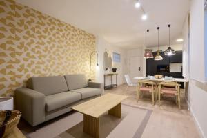 a living room with a couch and a table at MOON Apartments in Seville