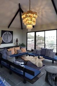 a living room with blue couches and a chandelier at SanRosa Boutique Hotel BnB in Bulalakao