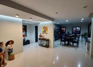 a living room with a family room and a dining room at SanRosa Boutique Hotel BnB in Bulalakao