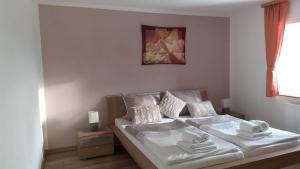 a bedroom with a bed with towels on it at Ferienhaus-Feinen in Lierfeld