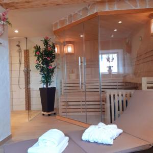 a sauna with two towels on a bench in a room at Ferienhaus-Feinen in Lierfeld +26 photos