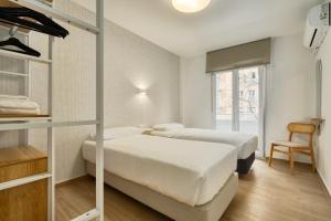 two beds in a room with a bunk bed at MOON Apartments in Seville +34 photos