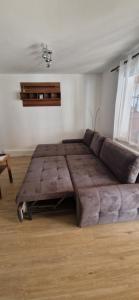 a large bed in a room with a couch at Bungalow Helga in Fürstenwalde