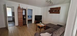 a living room with a couch and a television at Bungalow Helga in Fürstenwalde