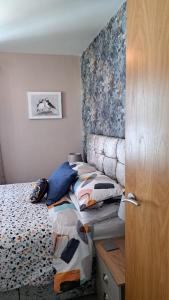a bedroom with a bed with pillows on it at Rock Quay in Killyleagh