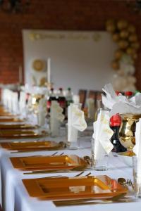 a long table with plates and napkins on it at Villa Neve in Ustrzyki Dolne