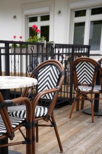 a couple of chairs and a table on a porch at Villa Neve in Ustrzyki Dolne