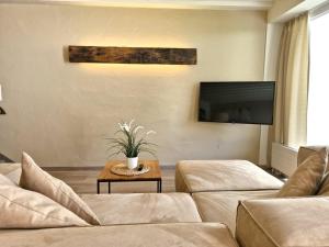 a living room with a couch and a table at Chalets St. Wendelin in Telfs