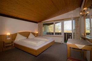 a bedroom with a large bed and a window at Chalets St. Wendelin in Telfs +39 photos