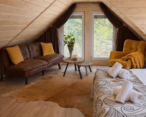 a living room with a bed and a couch at Gajówka in Istebna
