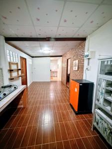a large room with a kitchen with a wooden floor at Cozy Beach House , 5 mn from the Sea -Self Check in in Ban Laem Sai