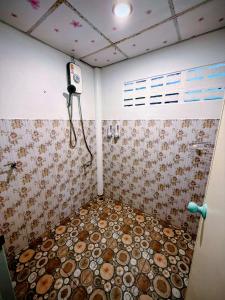 a room with a shower with a tiled floor at Cozy Beach House , 5 mn from the Sea -Self Check in in Ban Laem Sai