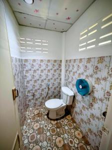a bathroom with a toilet and flowers on the wall at Cozy Beach House , 5 mn from the Sea -Self Check in in Ban Laem Sai +2 photos