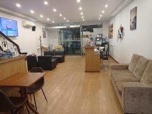 a living room with a couch and a table at Hotel Paulista in Porto