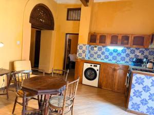a kitchen with a table and a stove top oven at Busara house 2 in Zanzibar City