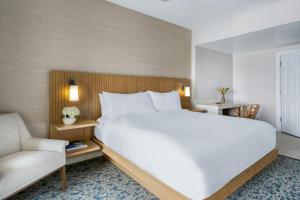 a bedroom with a large white bed and a chair at Marriott BeachPlace Towers 1BD in Fort Lauderdale +33 photos