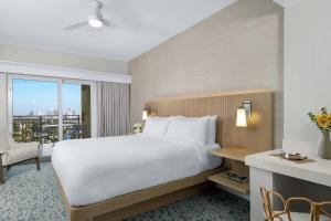a bedroom with a large white bed and a window at Marriott BeachPlace Towers 1BD in Fort Lauderdale