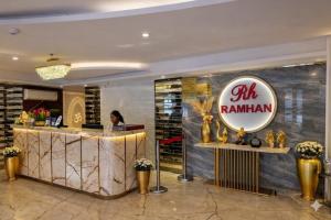 a woman sitting at a counter in a hotel lobby at Hotel Ramhan Palace in New Delhi